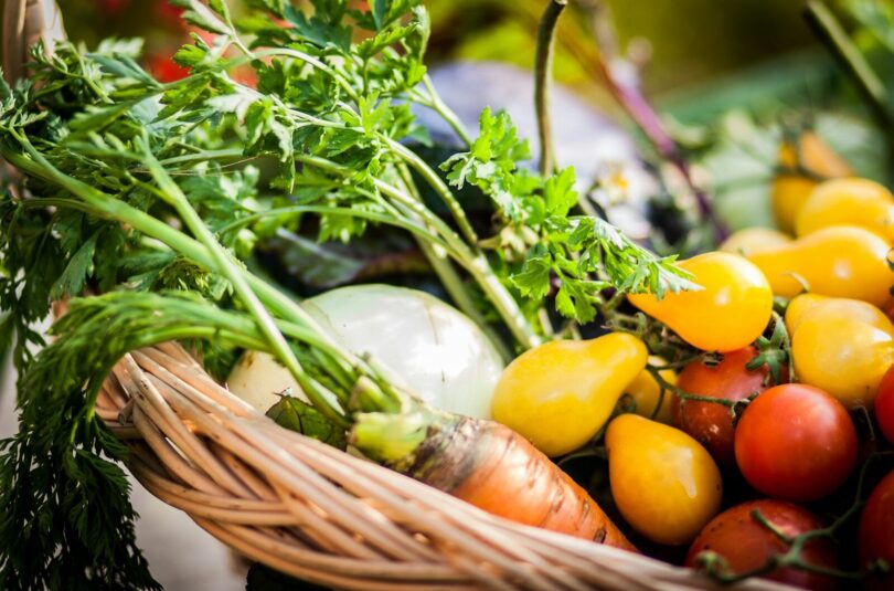 a basket filled with lots of different types of vegetables