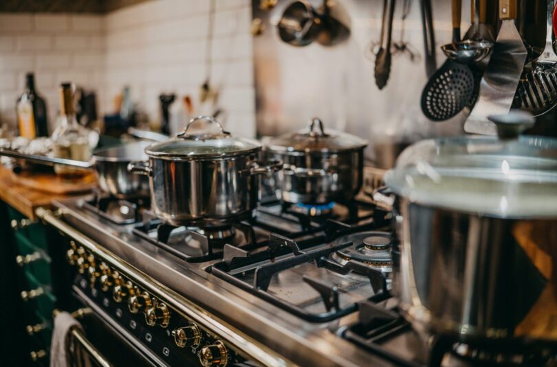 stainless steel cooking pots on gas stove